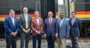 Among the officials participating in the Baton Rouge-New Orleans passenger rail inspection trip were (pictured left to right): Kansas City Southern President and CEO Pat Ottensmeyer, who supplied the train; Amtrak President and CEO Stephen Gardner; Canadian Pacific President and CEO Keith Creel; Louisiana Gov. John Bel Edwards; Louisiana Department of Transportation and Development Secretary Shawn D. Wilson; and FRA Administrator Amit Bose. (Amtrak Photo by Tom Davidenko)
