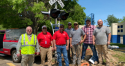 Part of the R.J. Corman team that helped install the new highway/rail grade crossing signals for Safety City, a safety program for second-graders run by the Lexington, Ky., Police Department. From left to right: R.J. Corman Signaling AVP of Engineering Signaling Rocky Metz; R.J. Corman Signaling General Manager Rich Barsalona; R.J. Corman Signaling Senior Systems Engineer Matthew Hamlin; R.J. Corman Railroad Services Signal Specialist Jared Lundy; R.J. Corman Railroad Services Signal Specialist Travis Lundy; R.J. Corman Railroad Services AVP of Signal Construction Larry Yeager; and R.J. Corman Railroad Services Signal Construction Ryan Hale. (Caption and Photograph Courtesy of R.J. Corman)