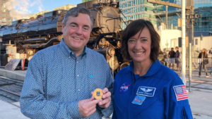 Astronaut Megan McArthur Behnken (right) returns the Big Boy locomotive challenge coin that she brought into space to Scott Moore, Union Pacific Senior Vice President-Corporate Relations and Chief Administrative Officer (left). (Caption and Photograph Courtesy of UP)