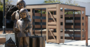 The memorial at the San Bruno BART Station plaza based on a Dorothea Lange photograph of Mochida sisters departing for incarceration at Tanforan. (Photograph and Caption Courtesy of BART)