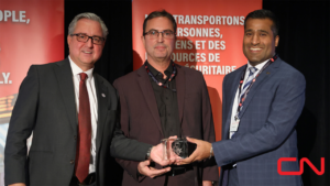 Pictured: CN’s Senior Director Operational Technology Luc Fiset and Chief, Technology and Supply Chain Rahim Karmali accepting the RAC 2022 Safety Award from RAC President and CEO Marc Brazeau. (Photograph Courtesy of CN, via Twitter)