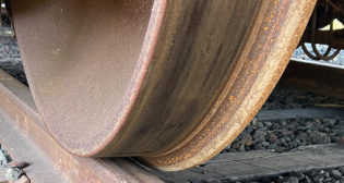 Figure 2: Photograph of a steel railway wheel in contact with a steel rail. (Courtesy of Gary T. Fry.)
