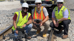 VisioStack and FEC officials (pictured) after a drone test using “automated machine vision technology to detect the track and navigate the drone’s flight path over the track within tight tolerances, without using GPS information or pilot input.” (VisioStack Photograph)