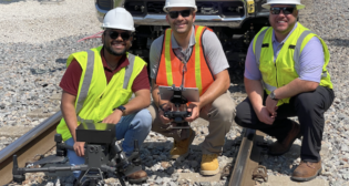 VisioStack and FEC officials (pictured) after a drone test using “automated machine vision technology to detect the track and navigate the drone’s flight path over the track within tight tolerances, without using GPS information or pilot input.” (VisioStack Photograph)