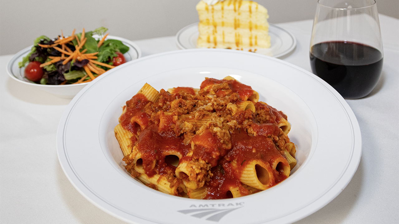 Traditional dining will be offered as an exclusive, complimentary amenity for riders traveling in First Class private rooms on Amtrak’s Silver Meteor and Silver Star. (Amtrak Photograph of Rigatoni Bolognese, a Dinner Option)