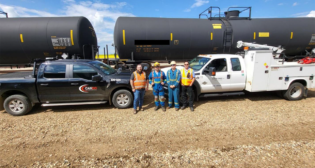 Pictured are Cando Superintendent Chris Greenaway and Assistant Superintendent Colin Love with Caltrax employees Damen Duczek, MRU Lead, and Kevin Gage, Vac Truck Operator and MRU Technician in the field, at Cando Sturgeon Terminal. (Caption and Photograph Courtesy of Cando Rail and Caltrax)