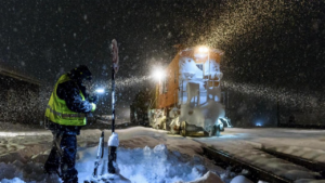 In the midst of a heavy snowfall, a brakeman lines a switch In Truckee, Calif. (Caption and Photograph Courtesy of UP)