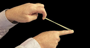 Figure 1. A stretched rubber band contains energy that we call “strain energy.” One component of strain energy is the “strain” in the band, which manifests as the band’s visible stretch. The other component of strain energy is “stress” which is invisible. (All illustrations courtesy of Gary T. Fry)
