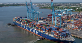 A glut of goods arriving over the past few years, including the CMA CGM Marco Polo’s May 2021 arrival shown here, has led to jam-packed warehouses and rampant discounts this holiday season. (Photograph Courtesy of PA/NYNJ)