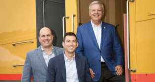 Standing next to one of the railcars in Union Pacific’s Heritage Fleet, from left are External Affairs team members Wes Lujan, Andrew Brady and Printz Bolin. (Caption and Photograph Courtesy of UP)