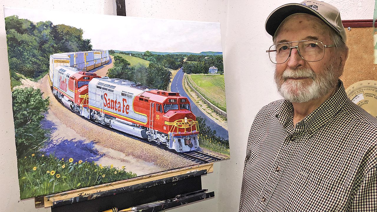 Lithograph and canvas giclee prints of railroad artist John Winfield’s 1993 “Warbonnet Renaissance” painting of red and silver Santa Fe 93 pulling a freight train through the Flint Hills of Kansas near Matfield Green (above) are available for sale by Great Plains Transportation Museum to aid in its effort to cosmetically restore Santa Fe 93. (Photograph Courtesy of Great Plains Transportation Museum)