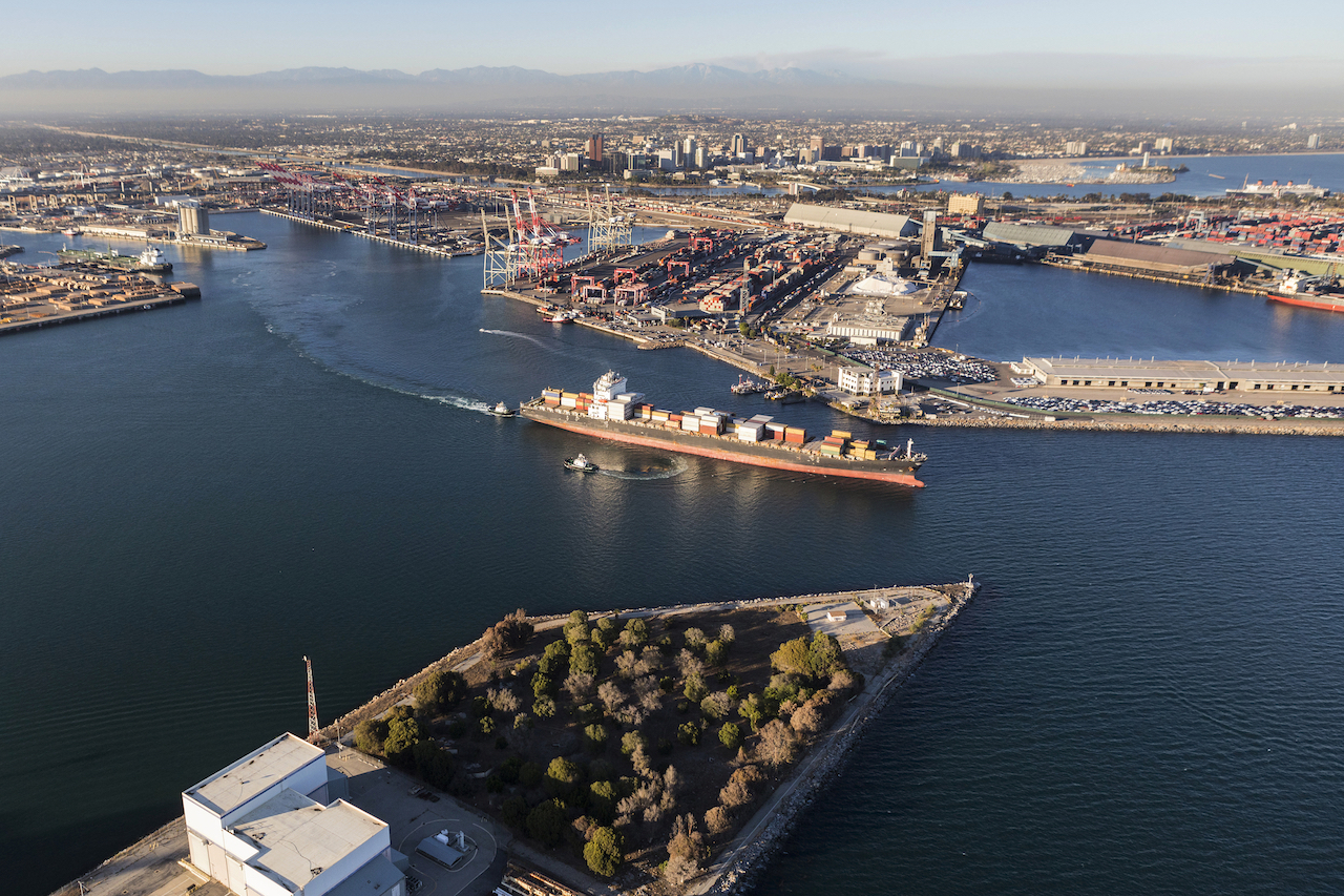 Aerial view of container cargo ship leaving Long Beach Harbor in Los Angeles County California. (Port of Long Beach photo)